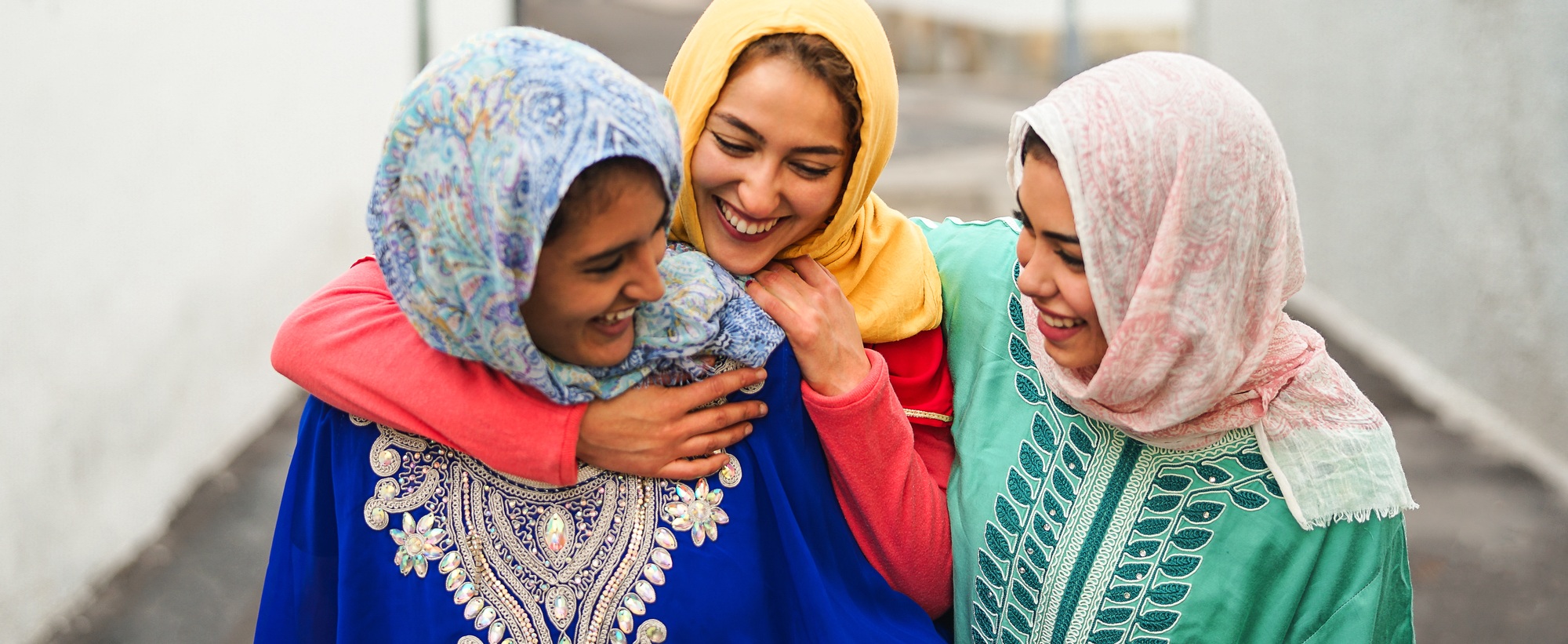 Happy Muslim women walking in the city center