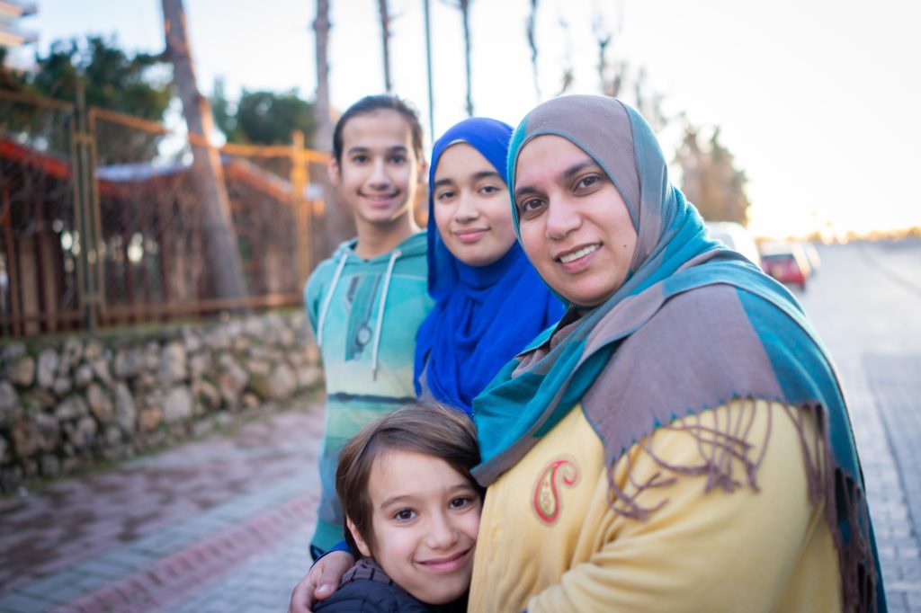 Real Muslim family on city street portrait